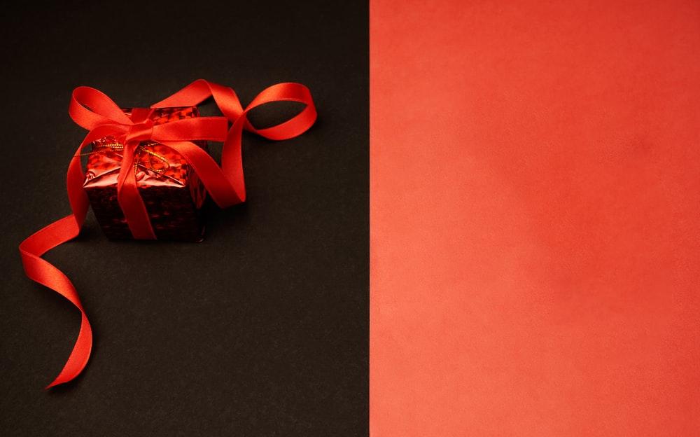 red and white ribbon on black surface